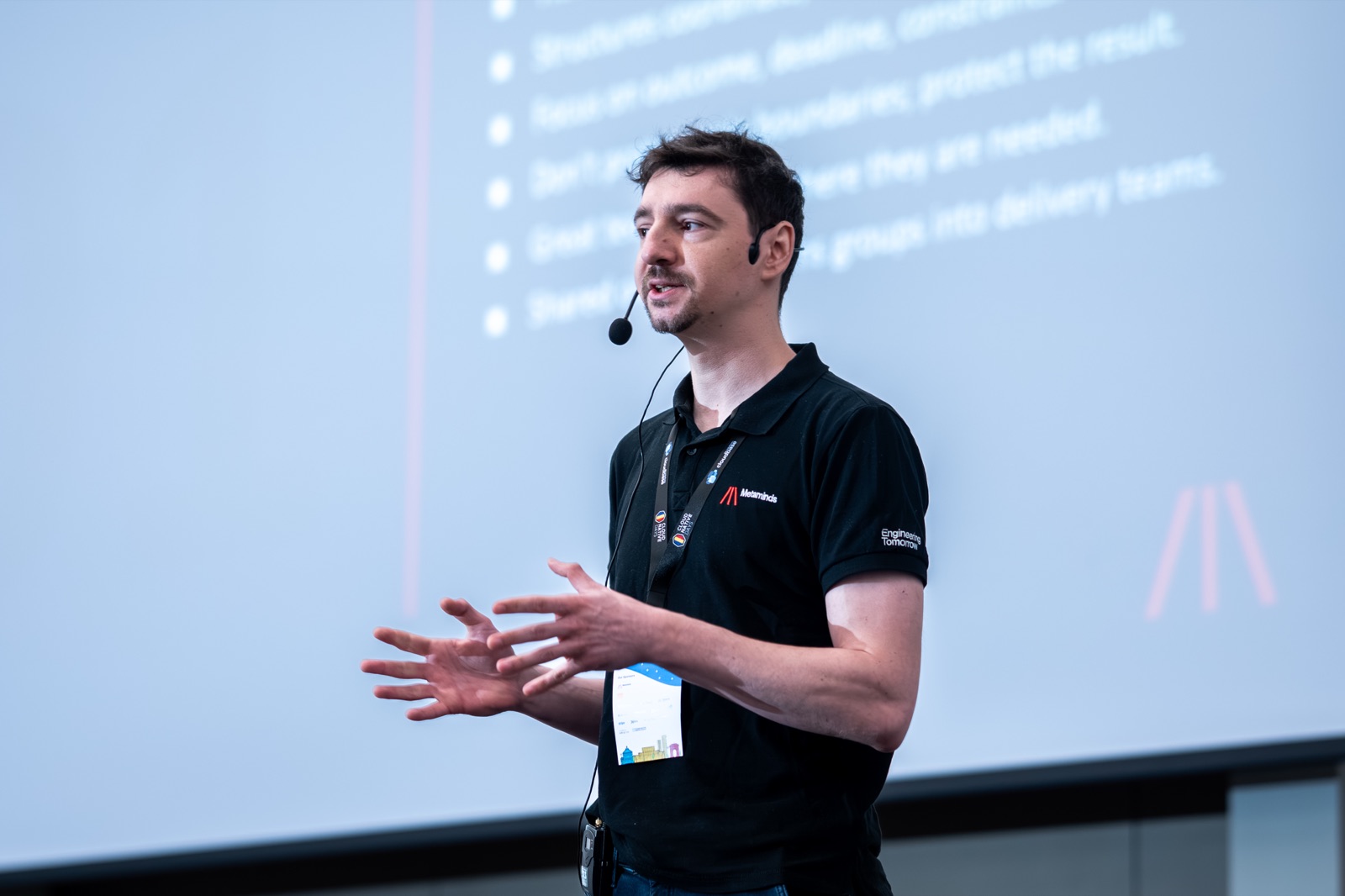On stage, making the case for team design — Cloud Native Days Romania 2026, Bucharest