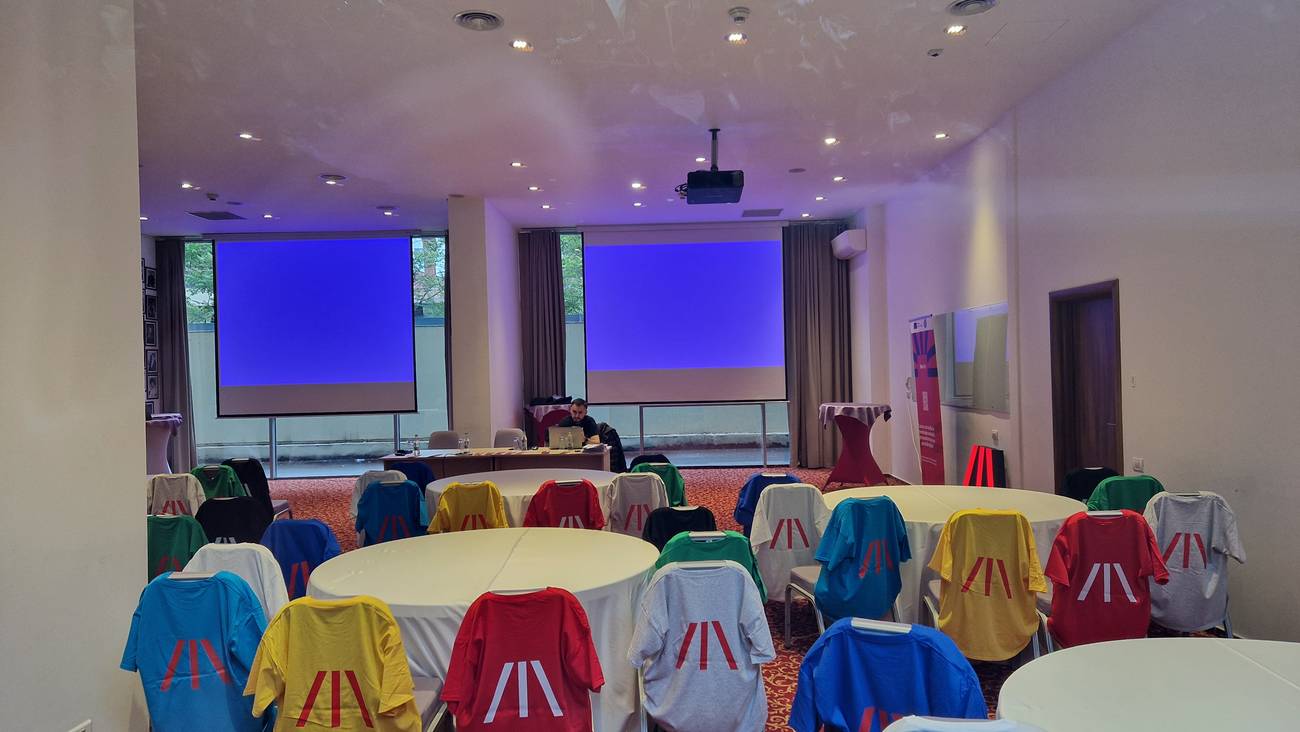 Plenary session — the student teams grouped by colour in the shared workshop